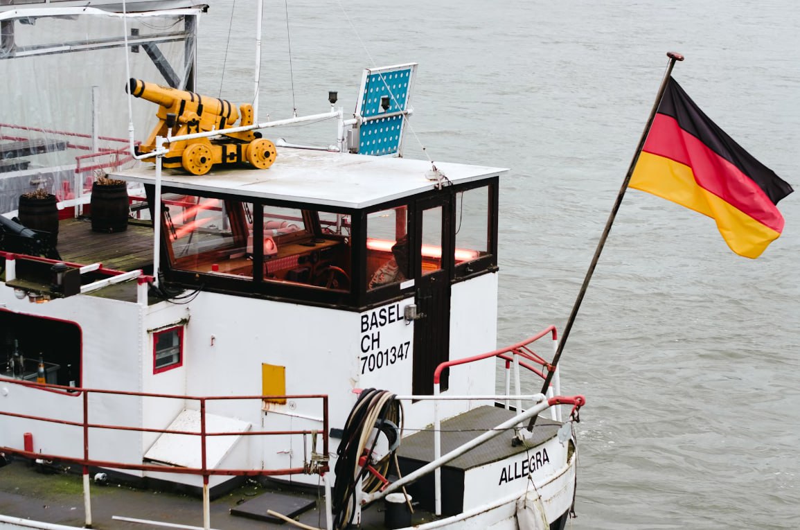 A Boat With A German Flag Flies Proudly