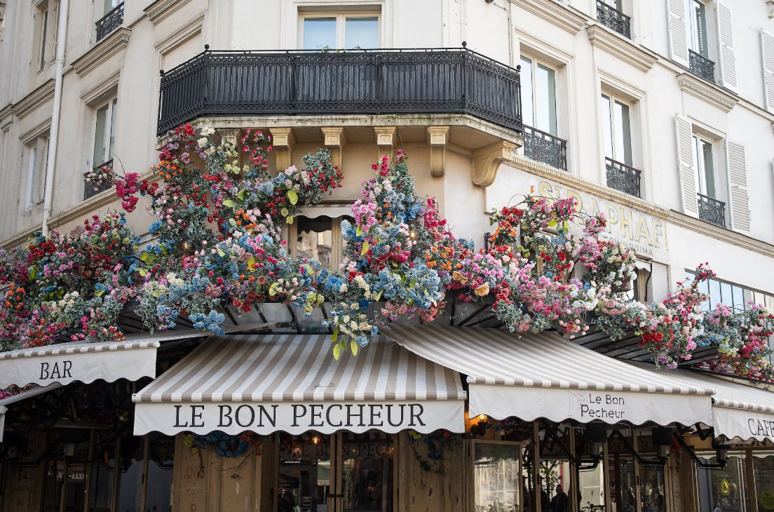 A Building That Has A Bunch Of Flowers On It