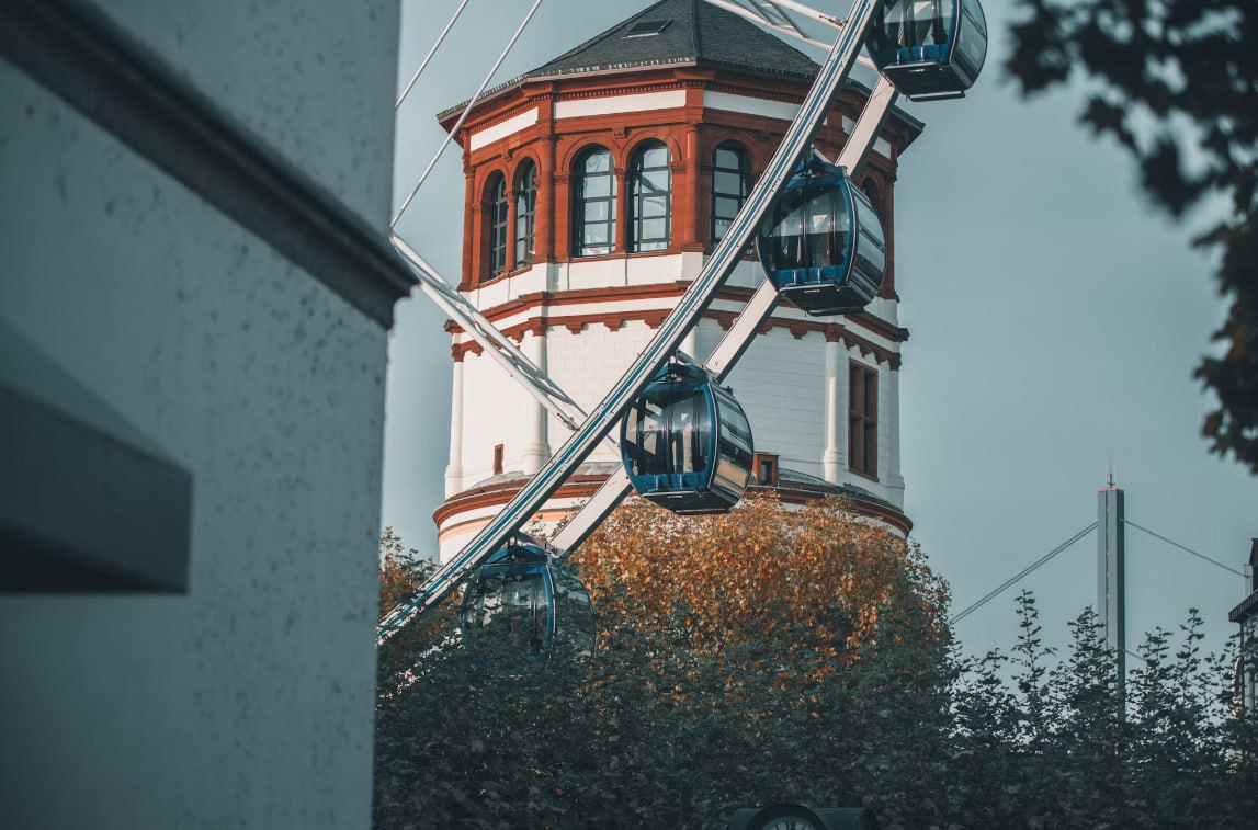 A Ferris Wheel Sitting In Front Of A Building