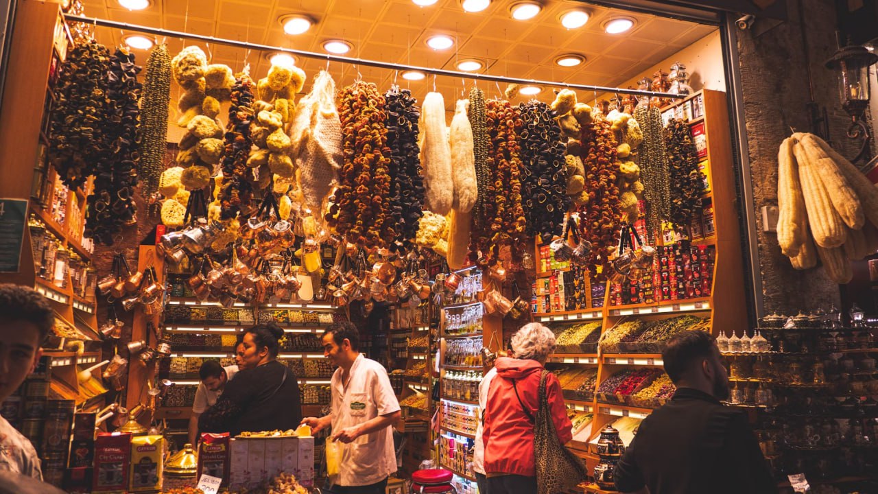 A Group Of People Standing In Front Of A Store