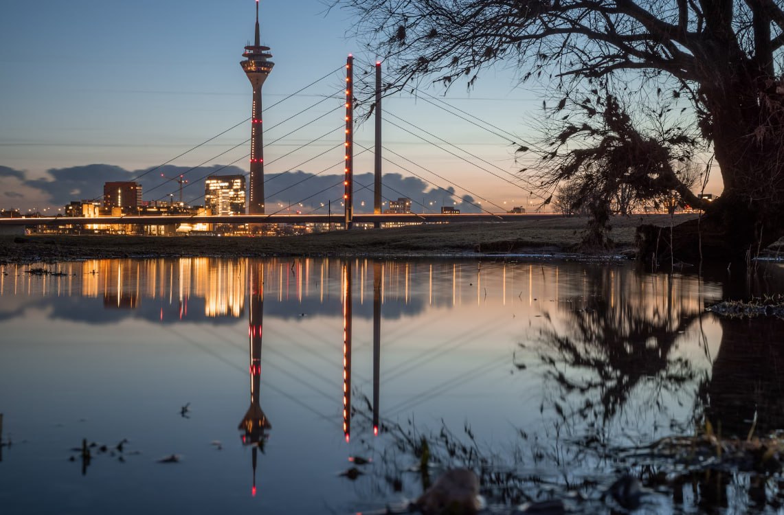 A Large Body Of Water With A Tower In The Background