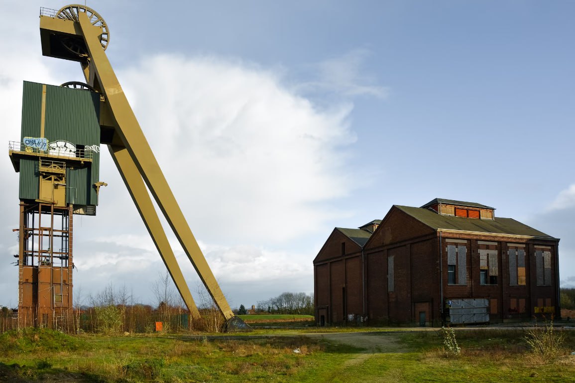 A Large Crane Sitting Next To A Building