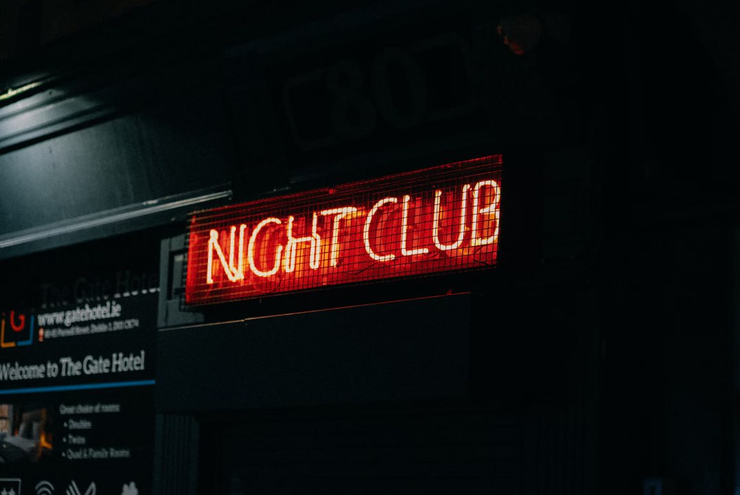 A Neon Sign That Says Night Club On