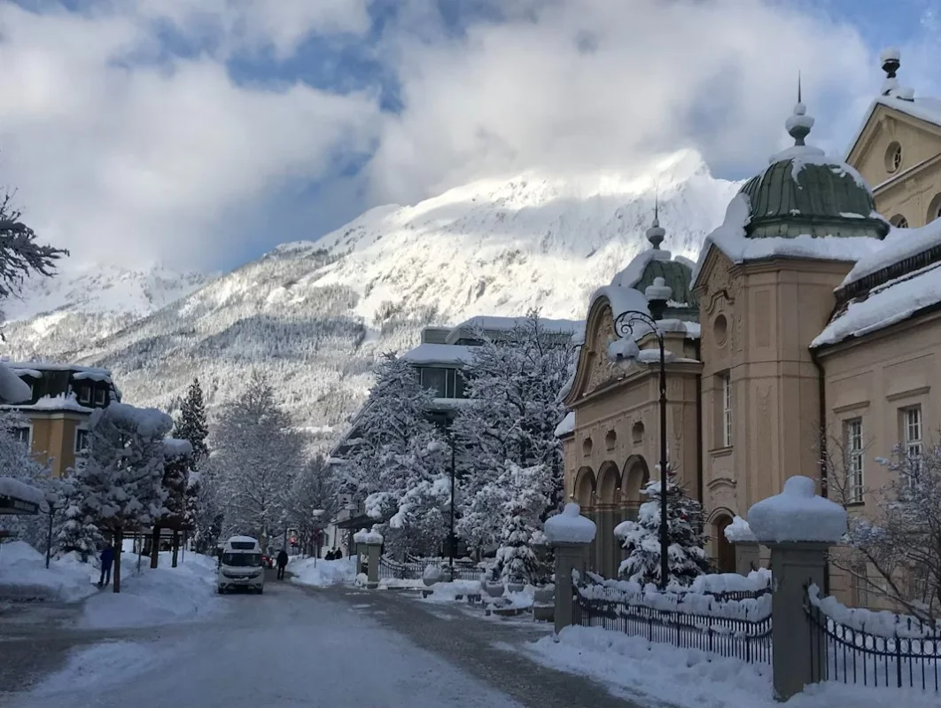 a-snow-covered-street-with-a-mountain-in-the-background