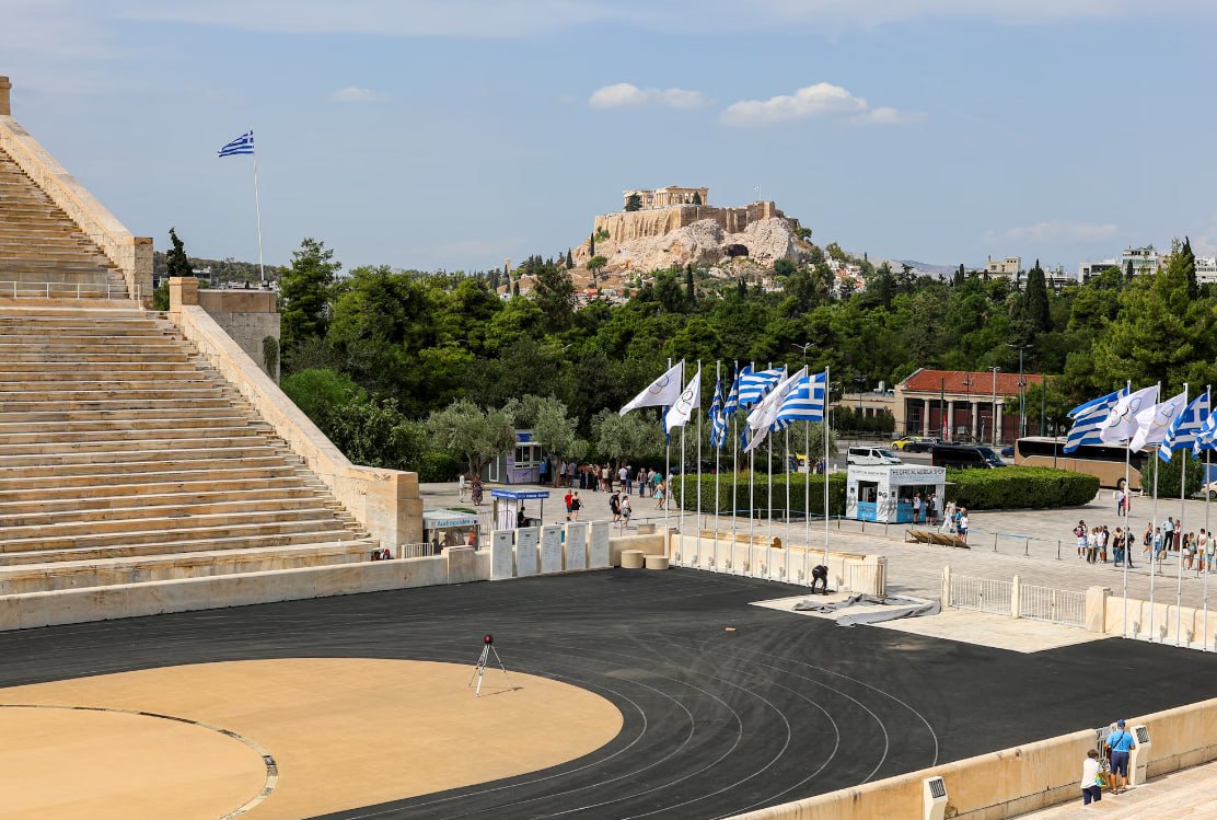 A Stadium With A Lot Of Flags In Front