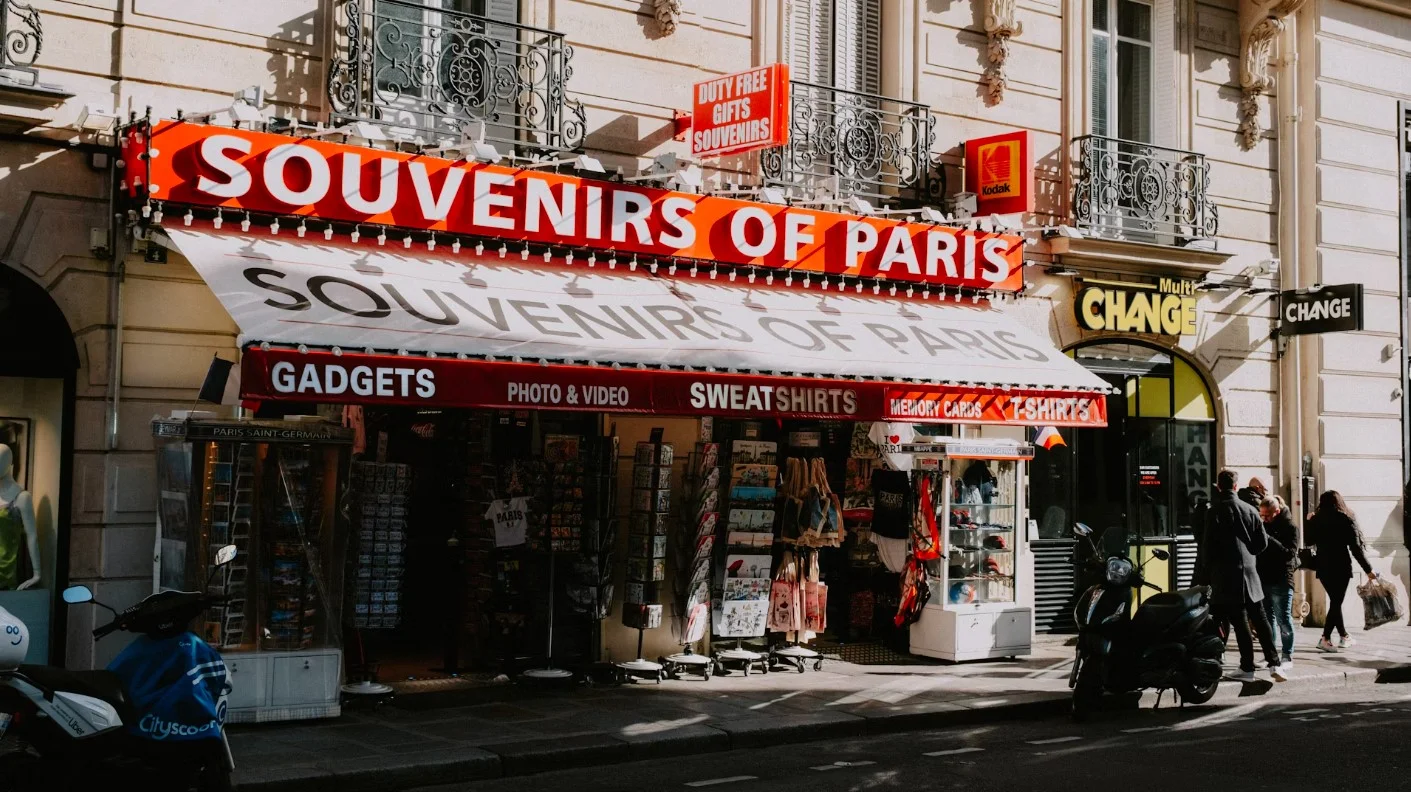 A Street Corner With A Store Called Souvenirs Of Paris