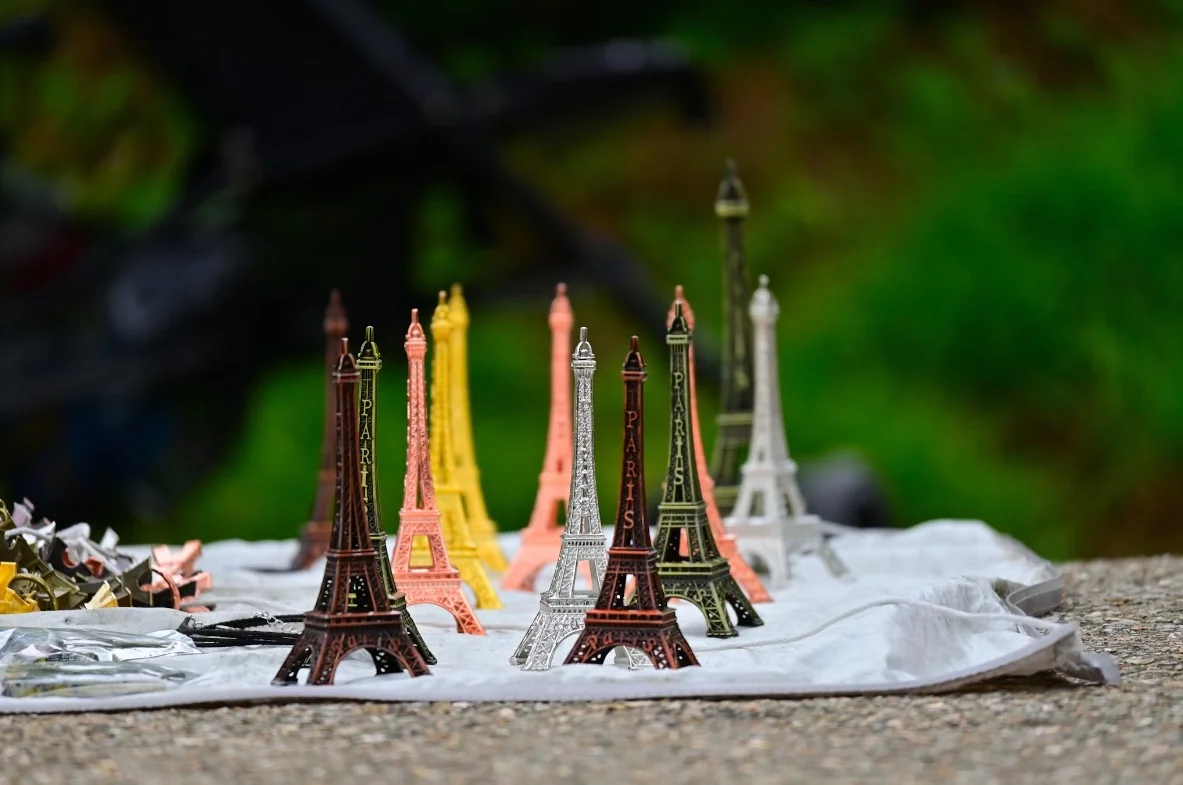 A Table Topped With Miniature Eiffel Tower Figurines