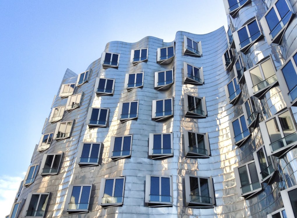 A Tall Building With Lots Of Windows On The Side