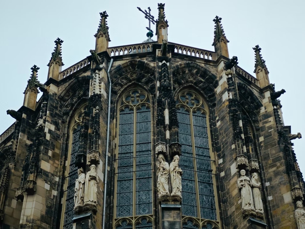 a-very-tall-building-with-statues-on-the-side-of-it