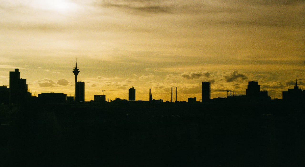 A View Of A City Skyline At Sunset