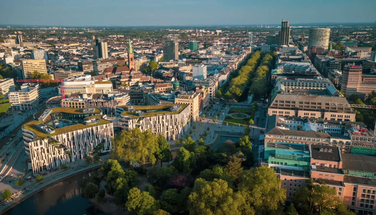An Aerial View Of A City With A River Running Through