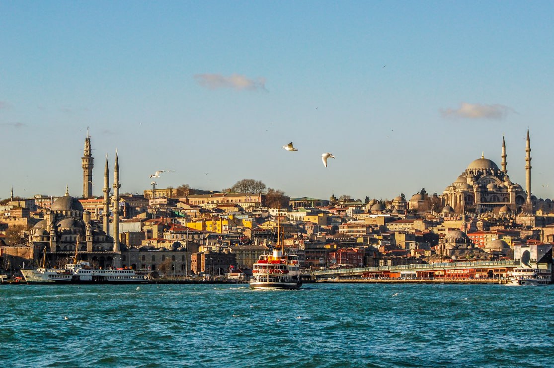 City Buildings Near Body Of Water During Daytime