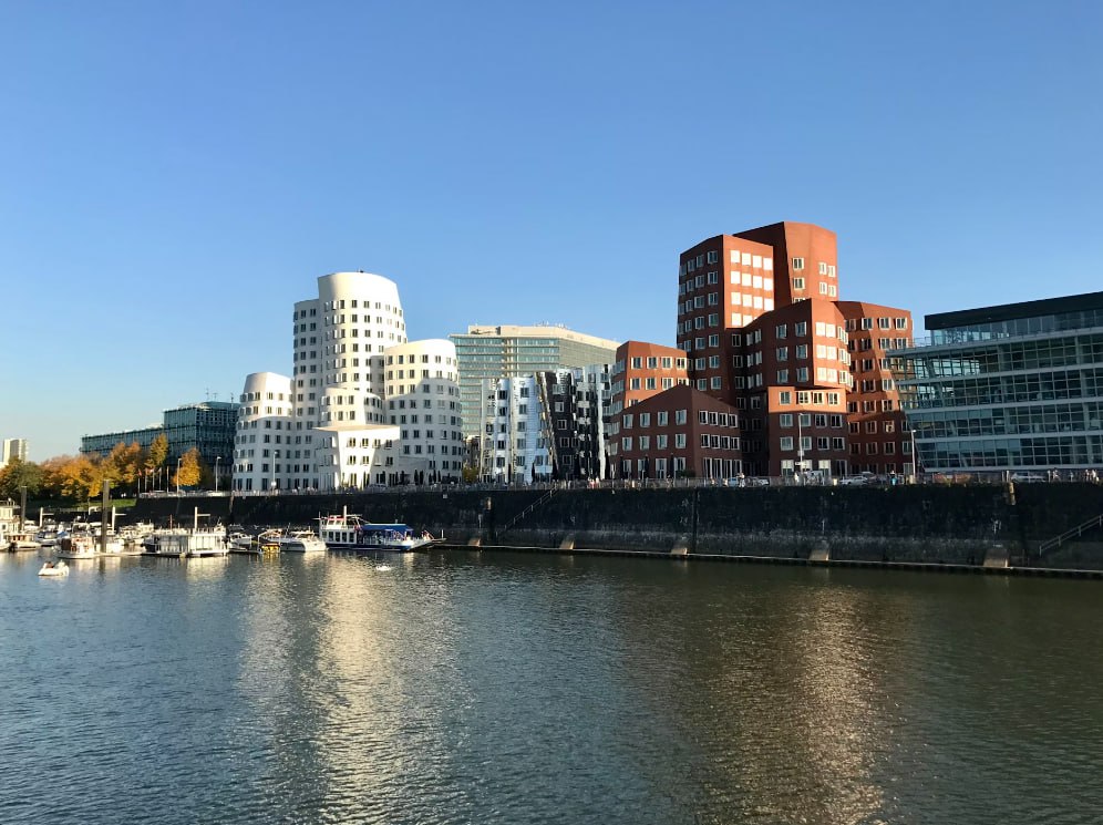 City Skyline Across Body Of Water During Daytime