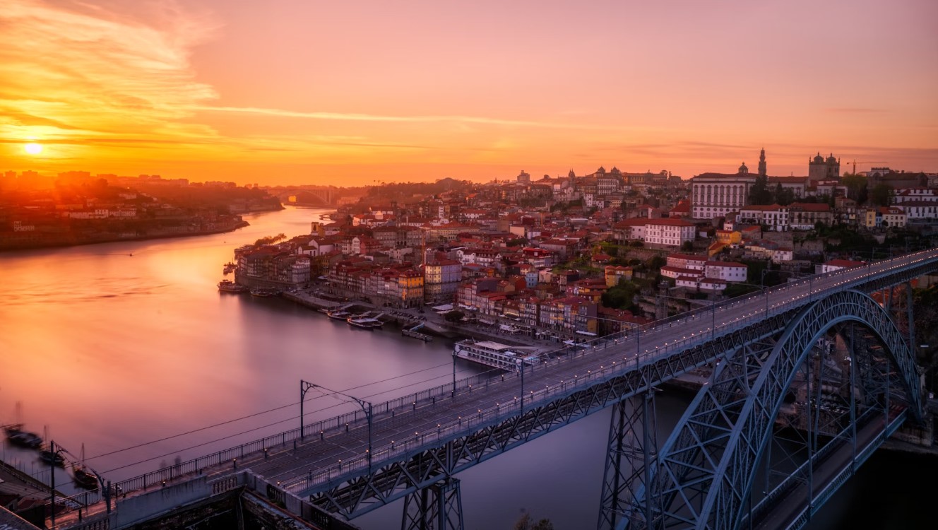 Gray Bridge Near Building At Sunset