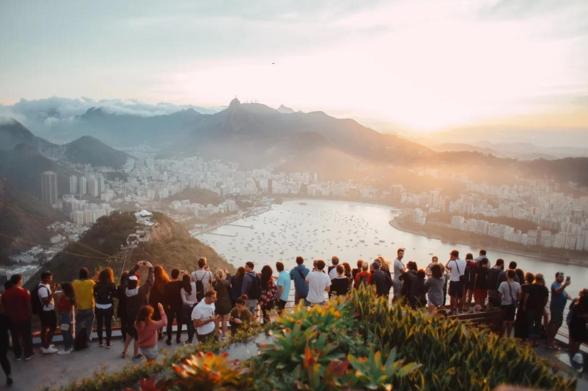 Group Of People Standing Facing Lake View