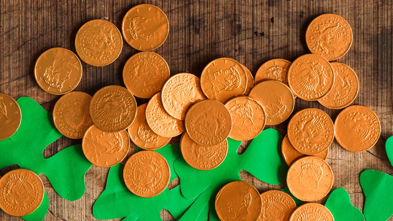 heap-coins-paper-shamrocks-wooden