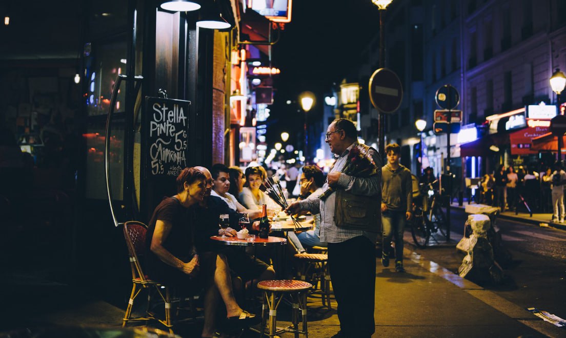 Man In Black Jacket Talking To Man And Woman