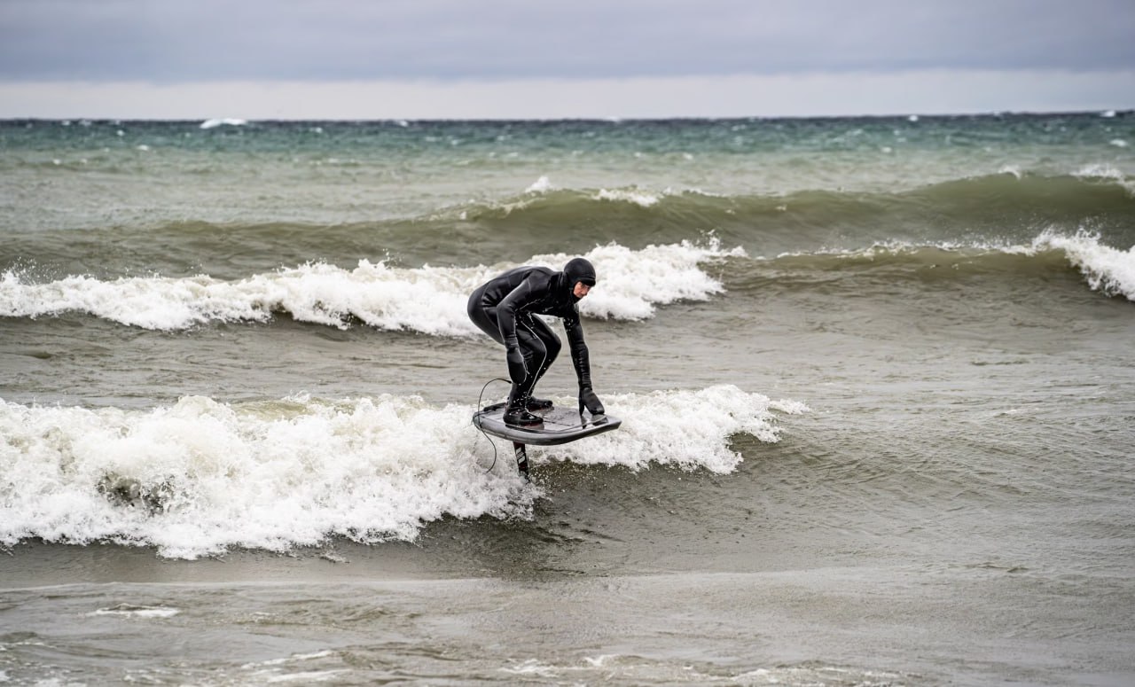 man_riding_a_surfboard_on_top_of_a_wave