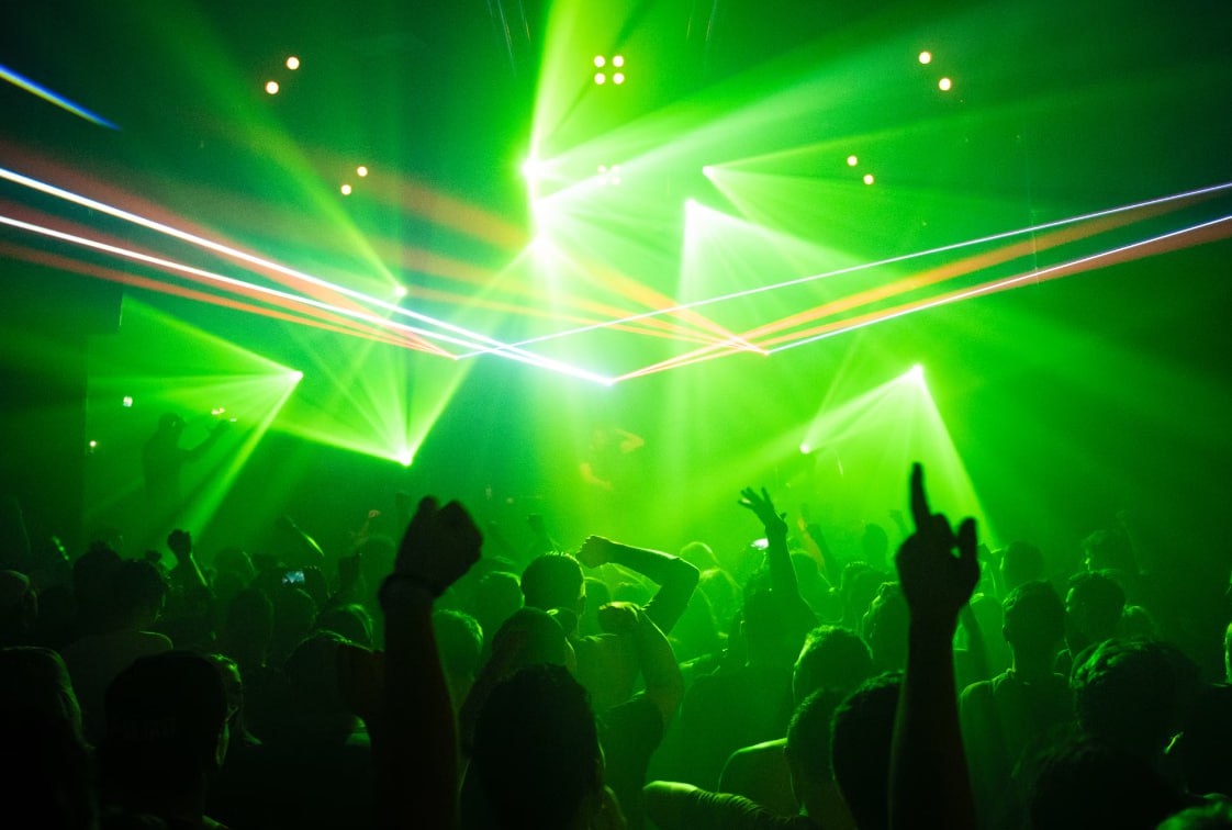People Dancing Inside Room With Green Lights