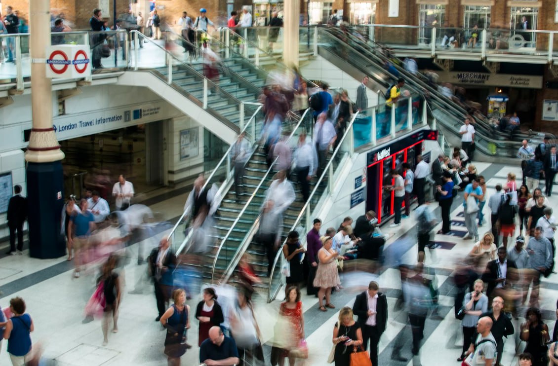 People Standing And Walking On Stairs In Mall