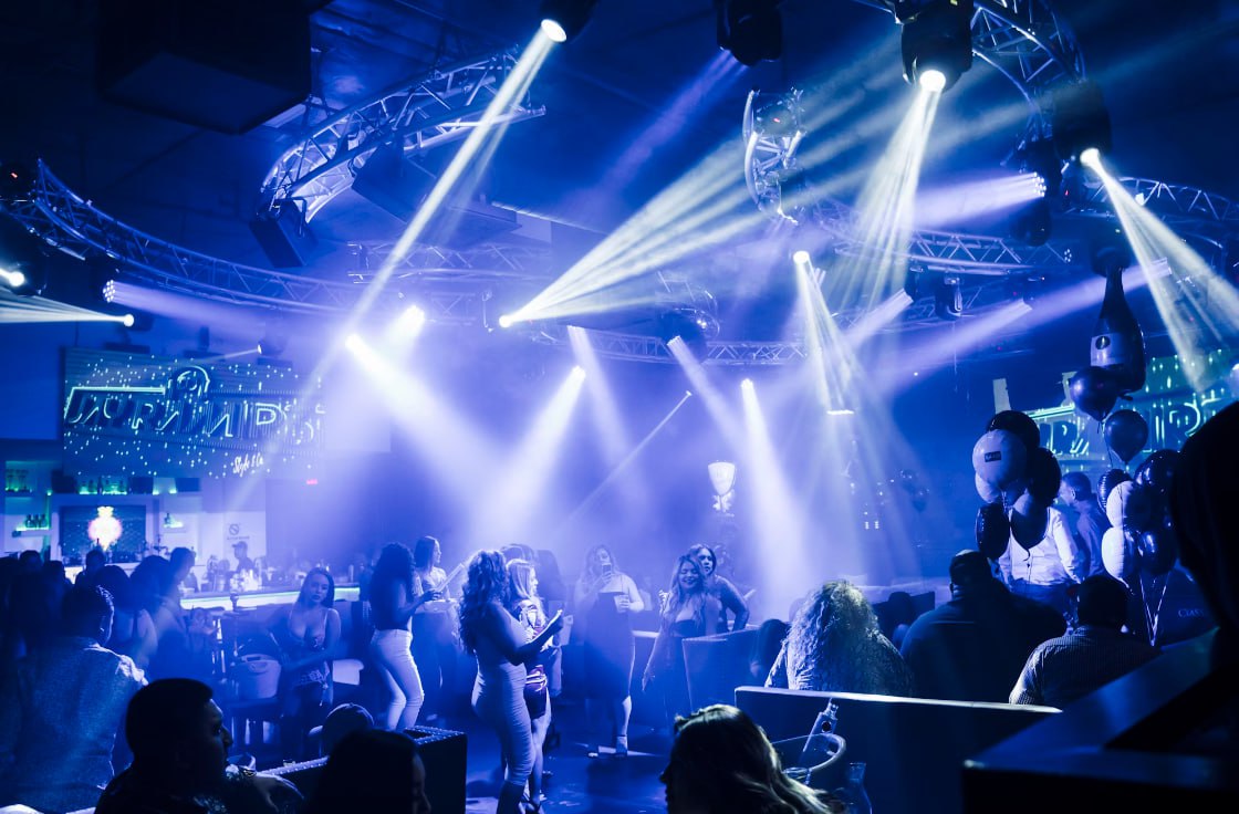 People Standing On Stage During Night Time