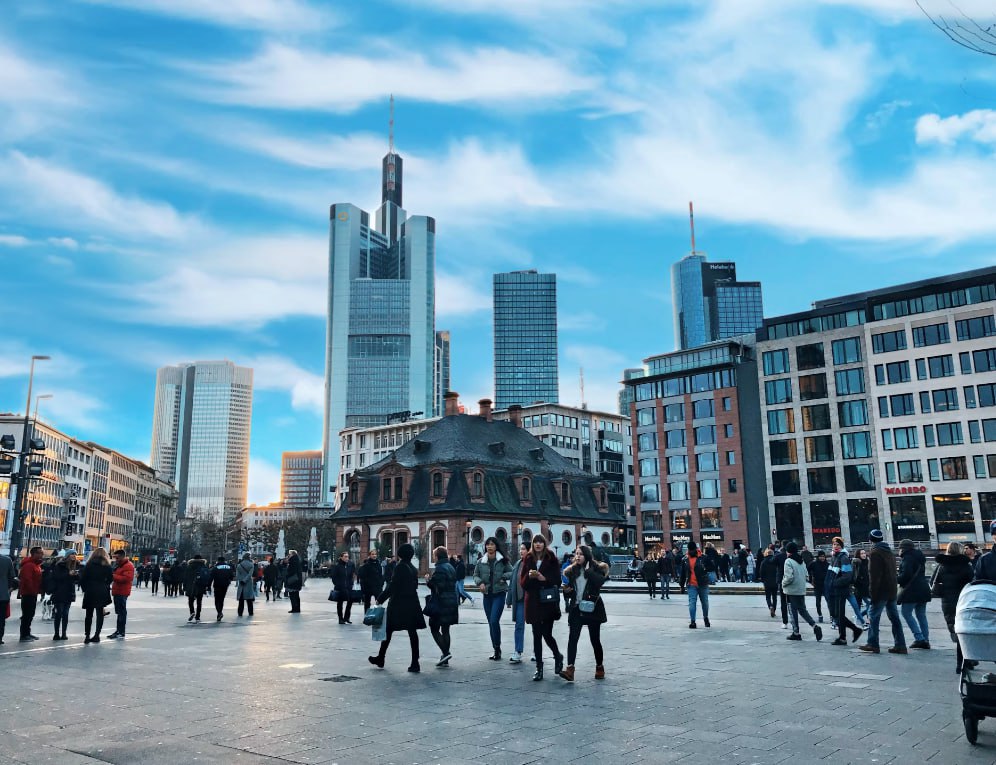 People Walking On Street Near High Rise Buildings During Daytime