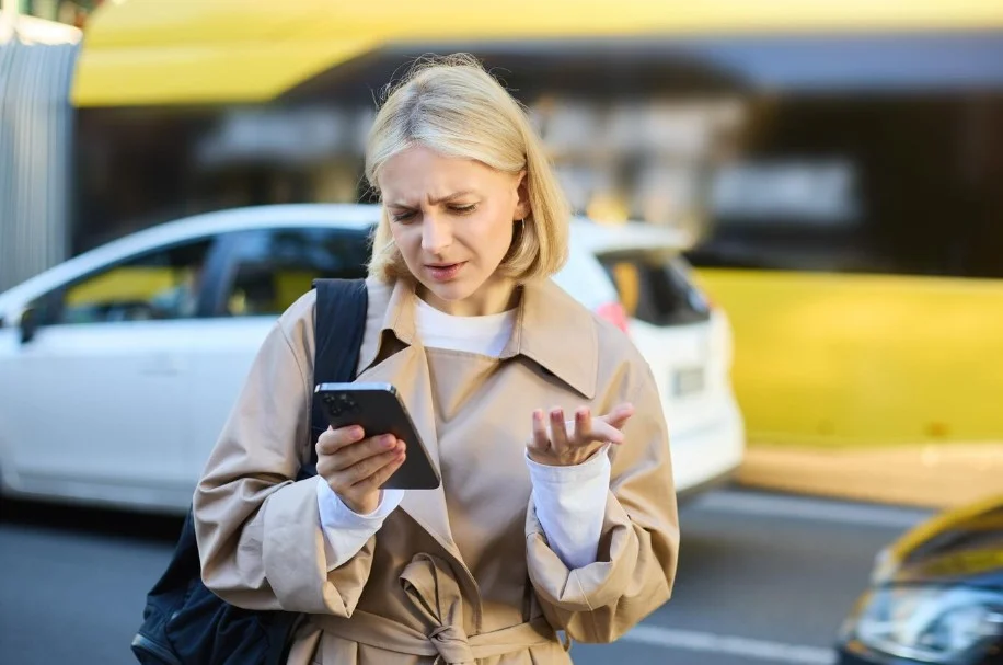 Portrait Young Confused Blonde Woman Standing Busy Street With Cars