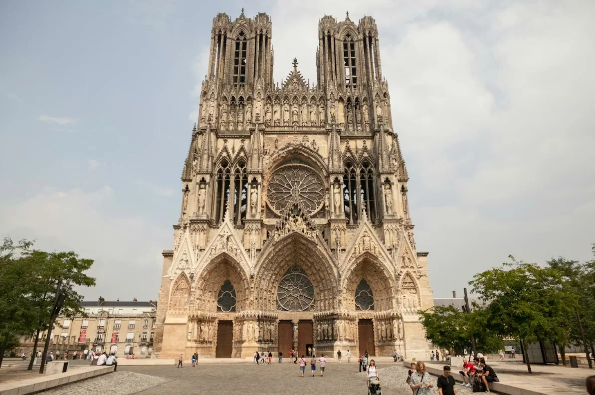 reims-people-walking-near-brown-concrete-building-during-daytime