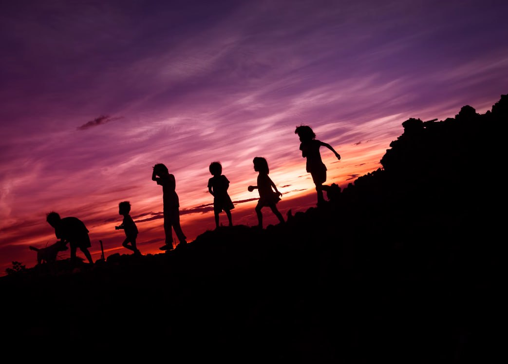 Silhouette Of Childrens Running On Hill