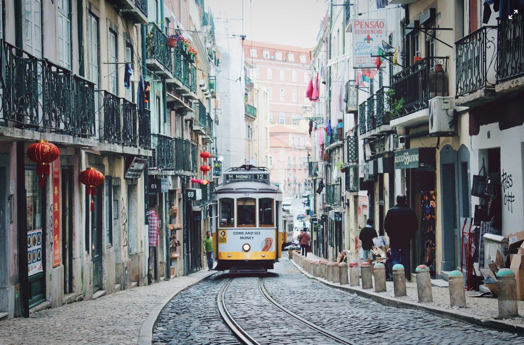 Train Passing In Between Buildings